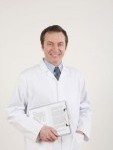 Man in lab coat holding a clipboard Stock Photo